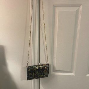 very cute and unique black crossbody purse with splashes of gold and silveer